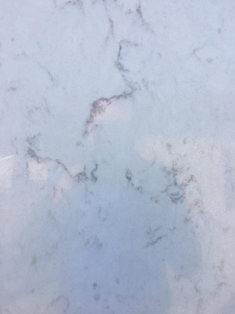 San Marino Quartz (close-up) - Hands on Granite